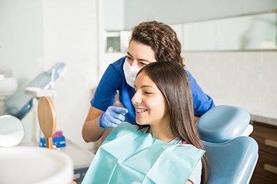 Orthodontic assistant showing smiling patient braces