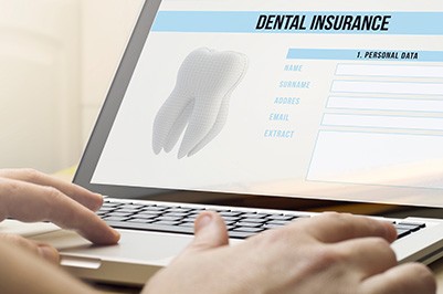 Person looking at dental insurance information on a laptop