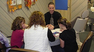 Dr. Cartwright and three patients sitting at table