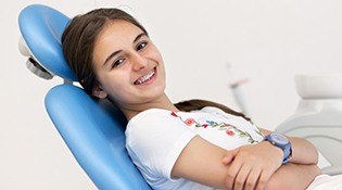 Smiling girl in dental chair