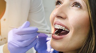 Woman with braces receiving exam