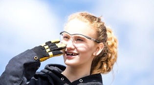 blonde headed girl smiling with braces