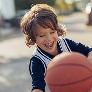 Young boy playing basketball