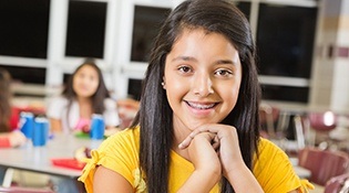 Smiling girl with braces at school