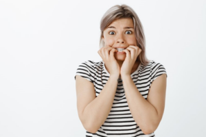 Woman with braces panicking because her teeth feel loose